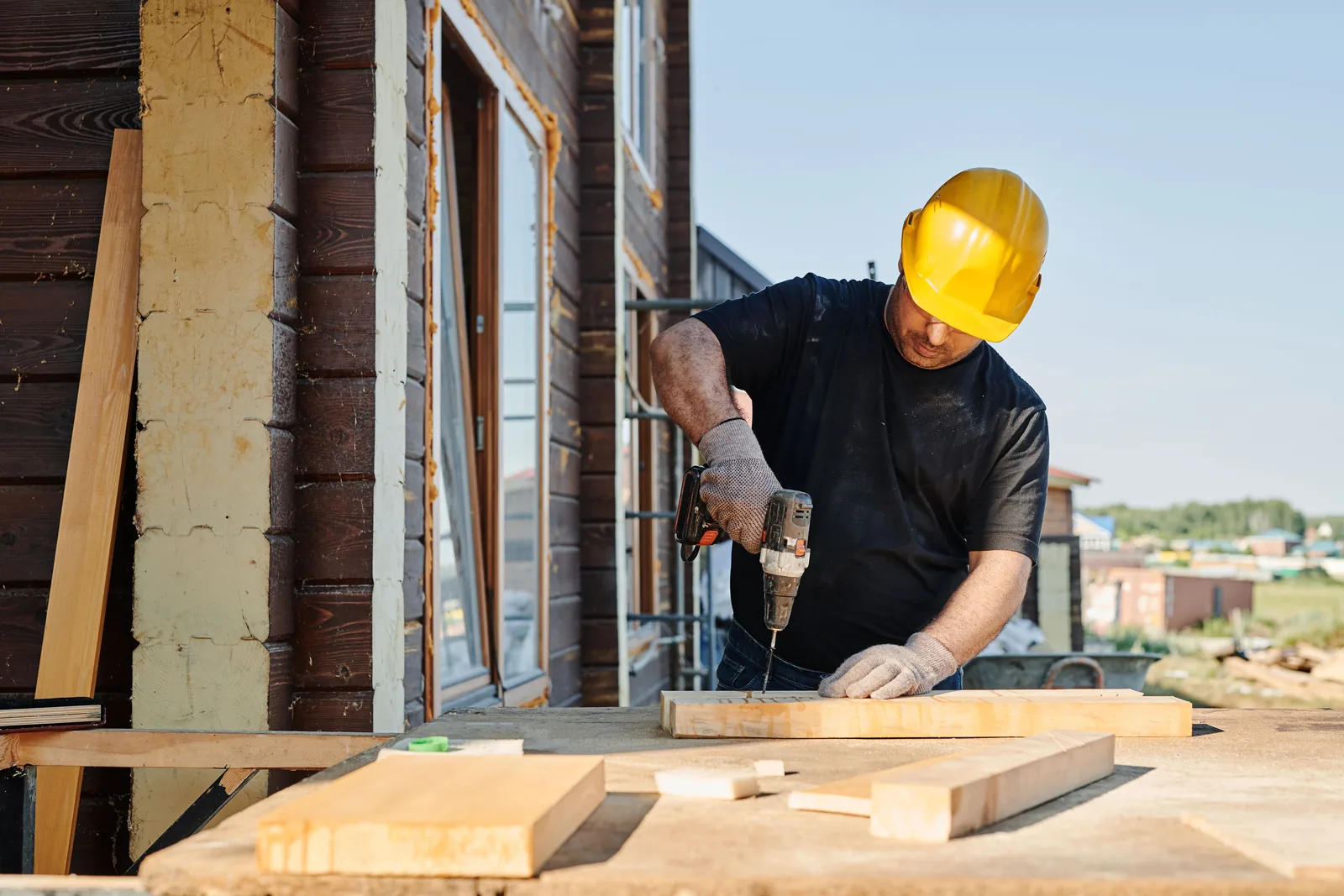 A construction business owner reviewing plans at a job site
