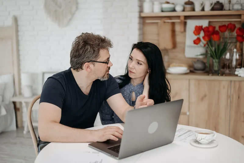 A couple reviewing their plan on a laptop